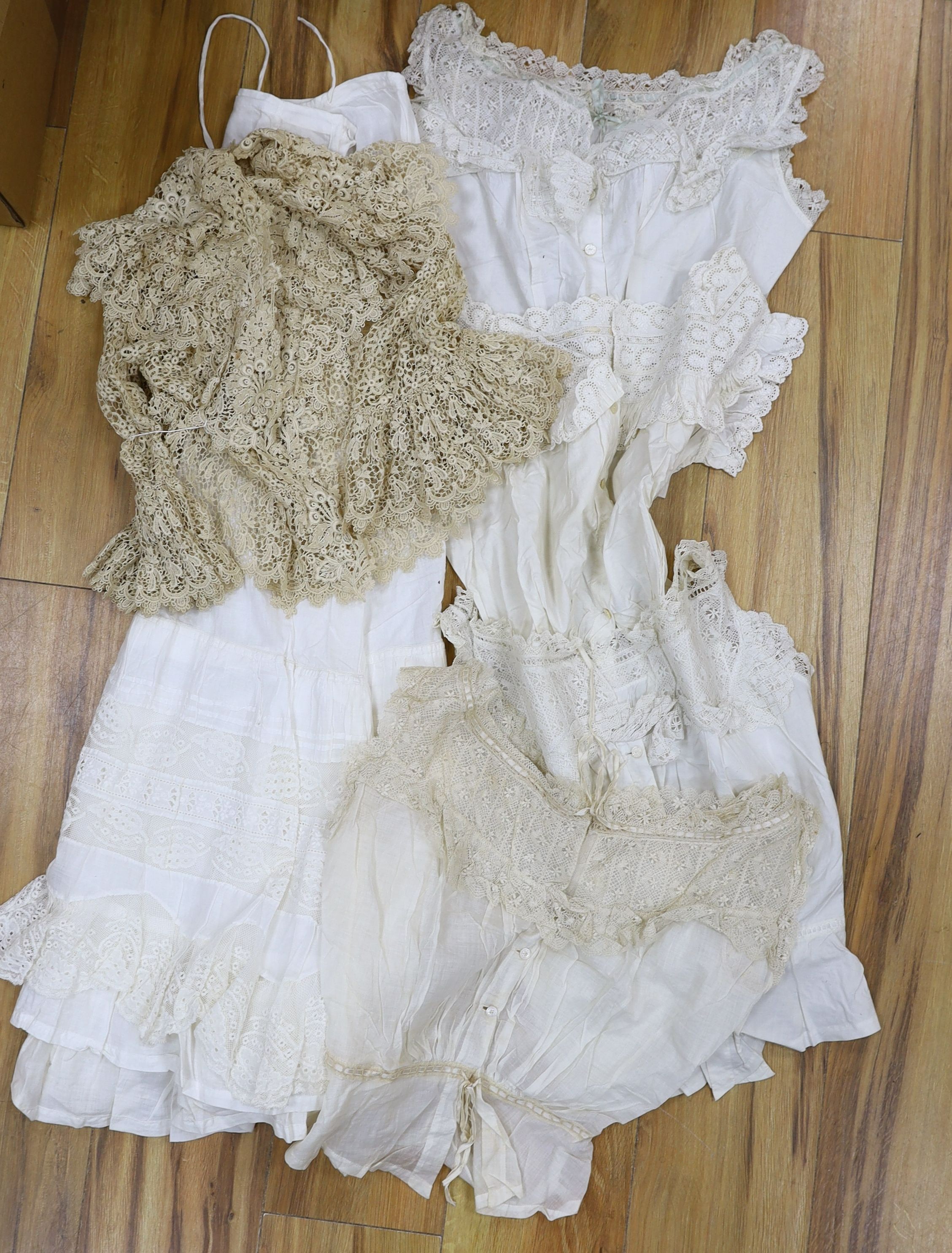 Five Victorian and Edwardian lace inserted camisole tops, a cream chemical lace jacket and a whitework and lace petticoat